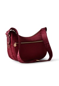 Burgundy leather shoulder bag with a curved silhouette, gold hardware, textured surface, and a logo-accented strap. Features a zippered pocket.