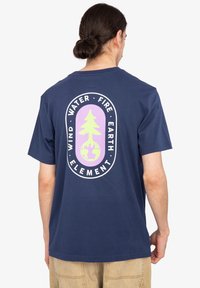 Navy blue cotton t-shirt featuring a large back graphic with a tree and globe, surrounded by the words "WATER, FIRE, EARTH, WIND, ELEMENT."