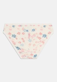 Cream-colored women’s bikini briefs with pink and blue floral print and scalloped edge detail at the waistband.