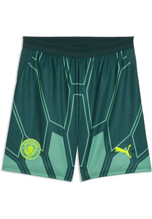 Grønne og sorte sportsshorts med geometrisk mønster og Manchester City-emblem på venstre ben og gul Puma-logo på højre ben.