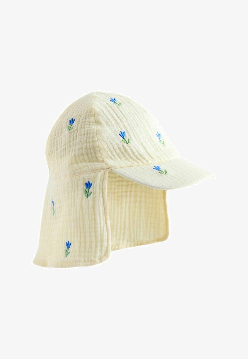 Casquette en tissu matelassé crème avec une large rabat couvrant la nuque, décorée de petites fleurs bleues brodées.
