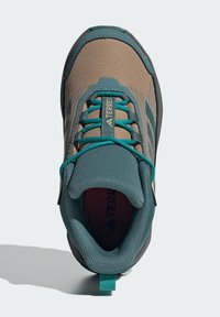 Lightweight hiking shoe featuring a brown synthetic upper, teal accents, textured mesh, and a padded collar for comfort.