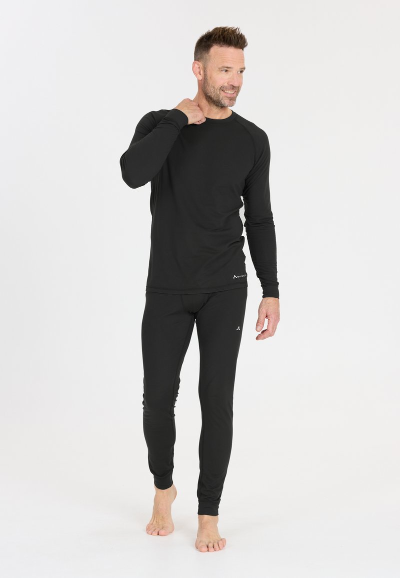 Black thermal top with long sleeves and matching fitted leggings. Smooth texture, minimalist design, featuring subtle brand accents.