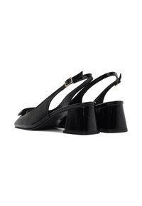 Black patent leather slingback shoes with a pointed toe, a small triangular heel, and a buckle on the ankle strap. Smoothing finish with subtle texture.
