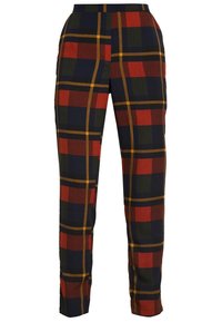 Slimmade byxor med stort rutig mönster i marinblått, rött, grönt och senapsgult på vit bakgrund.