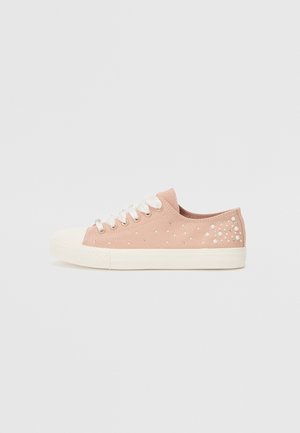 Pink canvas sneakers with white rubber sole, featuring decorative clear beads arranged in a dot pattern on the outer side. White laces.