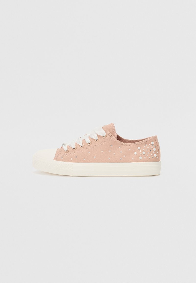 Sneakers in tela rosa con suola in gomma bianca, caratterizzati da perline trasparenti decorative disposte a motivo a pois sul lato esterno. Lacci bianchi.