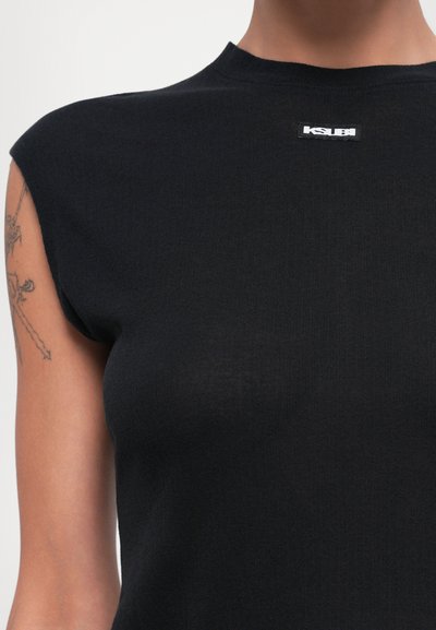 Black fitted t-shirt made of stretchy material, featuring short, structured sleeves and a small white KSUBI logo on the front.