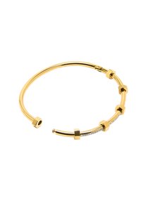 Bransoletka w kolorze złotym o zakrzywionym kształcie, z sześciokątnymi akcentami oraz rzędem małych, przezroczystych kryształków po jednej stronie.