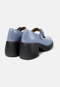 Blue leather shoes with a rounded toe, featuring a buckle strap and a textured black platform heel.