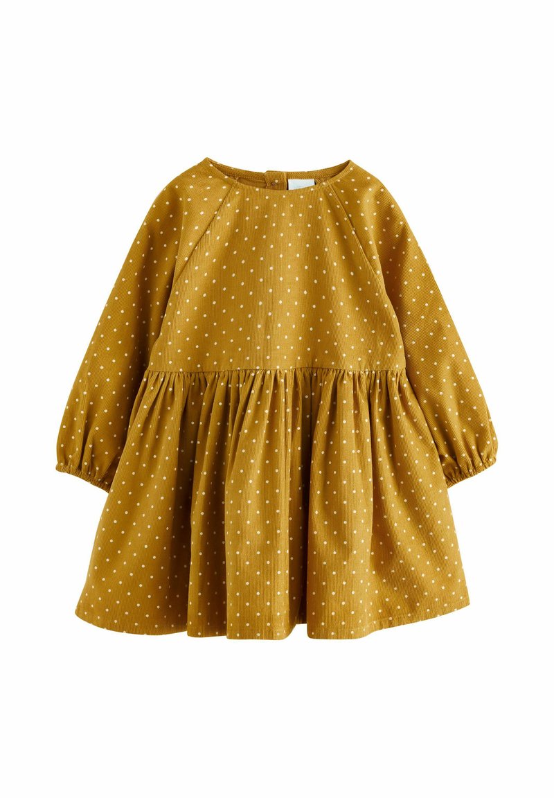 Abito giallo senape con pois bianchi, maniche lunghe, scollatura rotonda e gonna arricciata. Tessuto morbido, design casual.