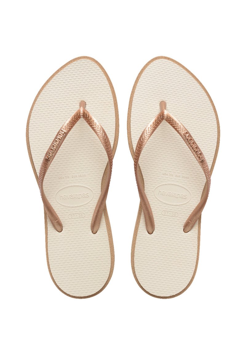 Brown rubber flip-flops with textured white soles. Features Havaianas branding and thin brown straps, shaped for comfort and ease of wear.
