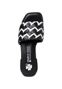 Black and white woven slide sandal with a flat sole, featuring a textured strap design and logo on the insole.