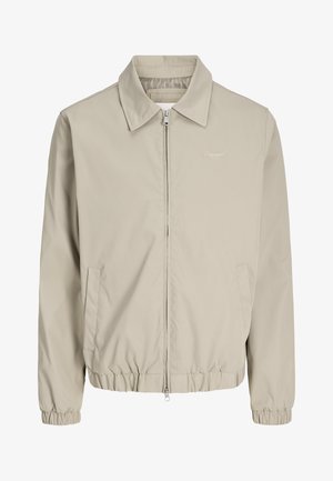 Meeste beež värvi lukuga jakk krae, elastsete varrukapitside ja alumise äärega, küljetaskutega ning rinnal peenelt tikitud "Originals" logoga.