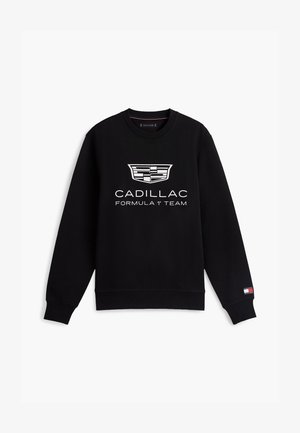 Hanorac negru cu mânecă lungă și guler rotund, cu logo-ul alb Cadillac și textul "Cadillac Formula 1 Team" pe față, logo mic Tommy Hilfiger pe mânecă.