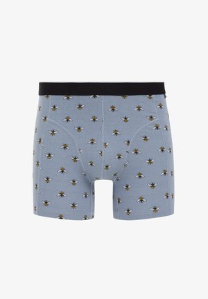 Herennachtkleding in lichtblauwe stof met een herhalend bijenpatroon in geel en zwart. Zwarte tailleband, zachte textuur en aansluitend ontwerp.