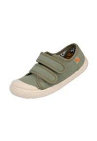 Zapatilla de lona verde con dos correas de velcro, puntera de goma beige y forro interior con un patrón de caras sonrientes. Suela de goma texturizada.
