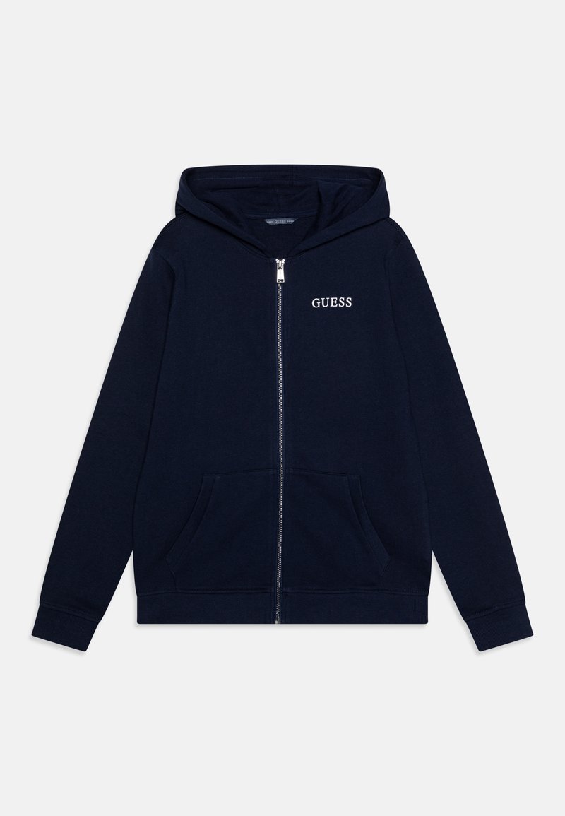 Sweat à capuche zippé bleu marine avec poche kangourou, manches longues, capuche et logo "GUESS" sur le côté gauche de la poitrine.