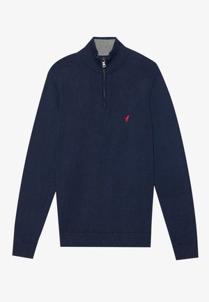 Suéter de punto azul marino con cuello alto y cremallera de cuarto, que cuenta con un interior de cuello gris y un pequeño logo rojo en el pecho.