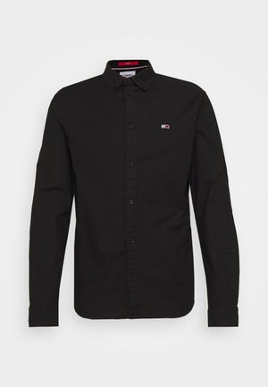 Black long-sleeve button-up shirt with a button-down collar and small rectangular logo on the left chest.