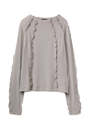 Long-sleeve light gray top with round neck and wavy vertical stitching details on front and sleeves, displayed on a white background.