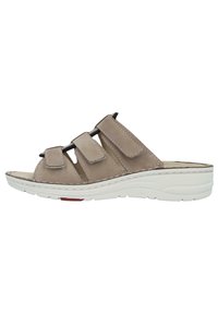 Beige leather slip-on sandal with three adjustable Velcro straps. Features a cushioned insole and a white rubber sole with slight elevation.