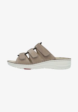 Beige leather slip-on sandal with three adjustable Velcro straps. Features a cushioned insole and a white rubber sole with slight elevation.