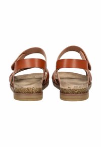 Braune Ledersandalen mit verstellbaren Riemen, Korkfußbett und flacher Gummisohle, die ein offenes Rückendesign für bessere Atmungsaktivität aufweisen.