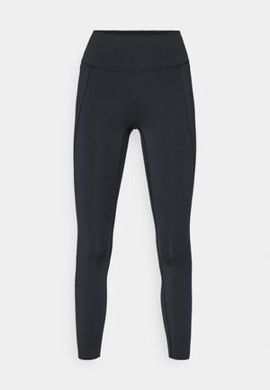 Leggings pretas de cintura alta, feitas de material elástico, com costuras reforçadas e uma textura suave. O design não apresenta logótipos ou padrões visíveis.
