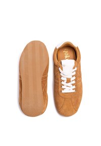 Brown suede sneakers with white laces and insoles, featuring a textured rubber sole and subtle stitching details.