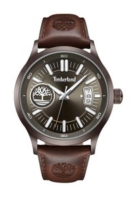 Reloj Timberland que presenta una correa de cuero marrón y una esfera metálica gris oscuro con marcadores blancos, un icono de logo y un indicador de fecha.