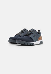 Navy mesh sneakers with gray suede accents, textured laces, and a white midsole. Features a rubber outsole with a tread pattern.