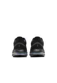 Paire de chaussures de sport noires vues de dos avec semelle coussinée et unité d’air visible sur fond blanc.