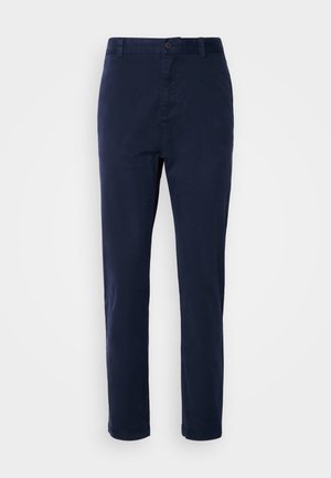 Tumši zili chinos izgatavoti no viegla auduma, ar taisnu kāju dizainu, pogu aizdari un sānu kabatām. Gluda tekstūra bez zīmējumiem.