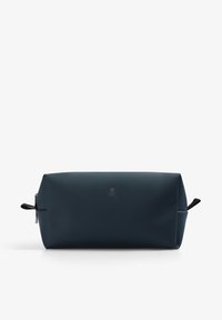 Navy blue toiletry bag with a rectangular shape, smooth matte texture, logo in the center, and two side handles.