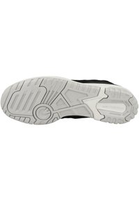 Black sneaker sole with textured white rubber. Features grooves and patterns for grip, with a circular emblem at the center.