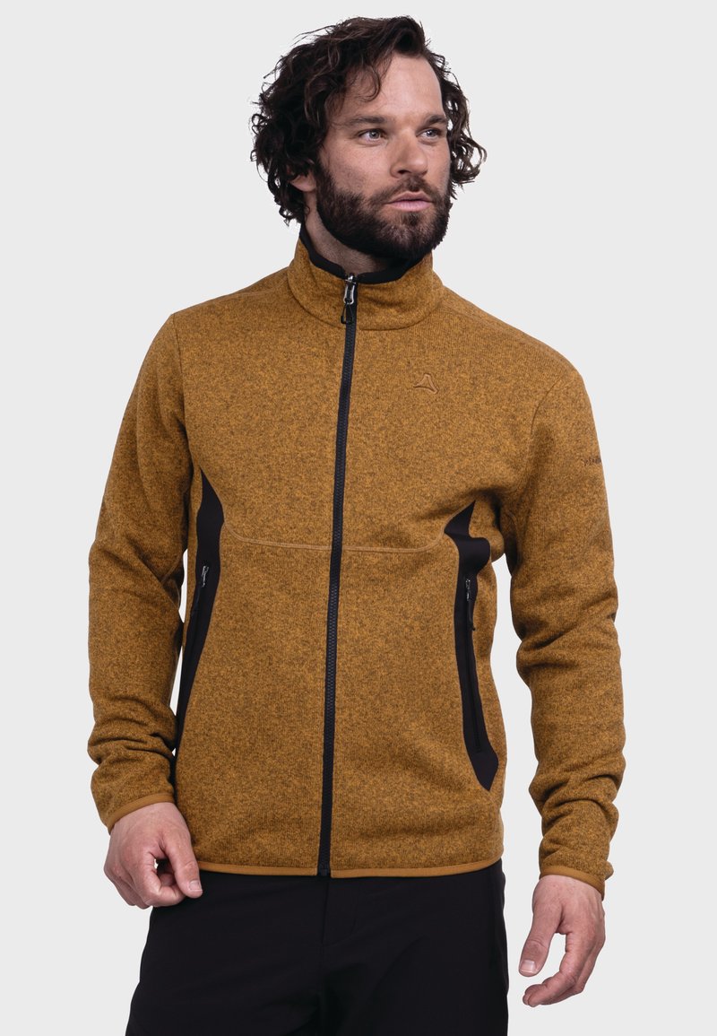 Fleece-Jacke in senfgelb mit hohem Kragen, Reißverschluss vorne und schwarzen Akzenten. Verfügt über strukturierte Stoffe und seitliche Reißverschlusstaschen.