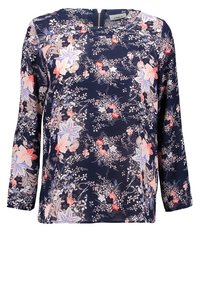 Blusa floreale navy con maniche lunghe, caratterizzata da una combinazione di fiori rosa, blu e bianchi. Tessuto morbido con dettagli zip sulla schiena.