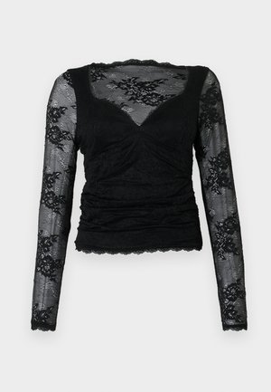 Melnas garas piedurknes blūze, kas izgatavota no mežģīnēm, ar rušinātu dizainu un viļņainām malām, ar ziedu rakstiem uz piedurknēm un V-veida kakla izgriezumu.