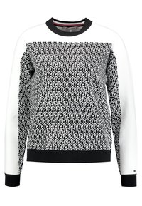 Felpa in cotone con un motivo geometrico in bianco e nero, polsini e fondo neri, e una parte superiore in bianco solido a contrasto. Collo rotondo.