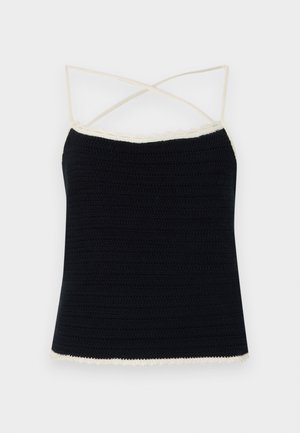 Black crochet camisole with cream scalloped trim, featuring crossed spaghetti straps and a fitted silhouette. Smooth texture with horizontal patterns.