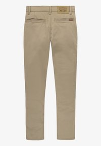 Chinos beige in cotone con design a gamba dritta. Presentano due tasche posteriori, una patch in pelle con logo e cuciture pulite.