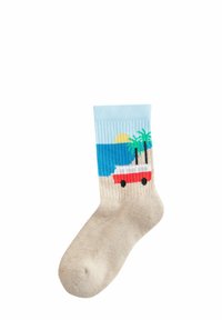 Beige sock featuring a beach scene with a light blue top, red car, palm trees, and a sun over the ocean, with a ribbed texture.