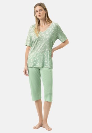 Light green loungewear set featuring a short-sleeved, floral-patterned top and cropped pants in a matching solid color. Soft fabric texture.