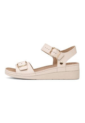 Beige wedge sandal with adjustable ankle and toe straps featuring gold-tone buckles and cushioned insole.