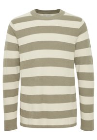 Stripet genser med rund hals, med vekslende lyse kremfargede og olivengrønne striper. Teksturert strikket stoff. Lange ermer.