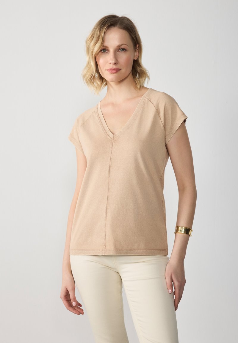 Beige cotton blend V-neck t-shirt with short sleeves, featuring a relaxed fit, subtle stitching details, and smooth texture.