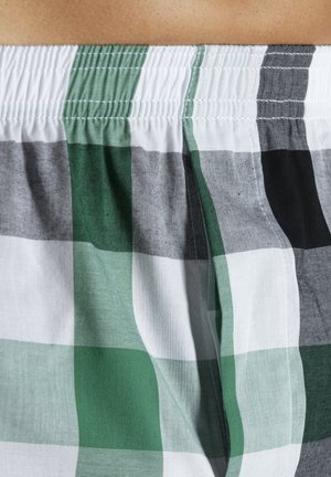 Green, gray, and white plaid fabric with a textured finish. Elastic waistband at the top. Pattern features large check squares.