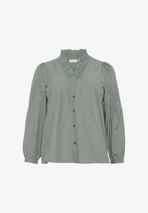 Blouse vert clair en tissu doux, avec un col à volants, une fermeture à boutons sur le devant et de longues manches bouffantes avec de subtils détails texturés.