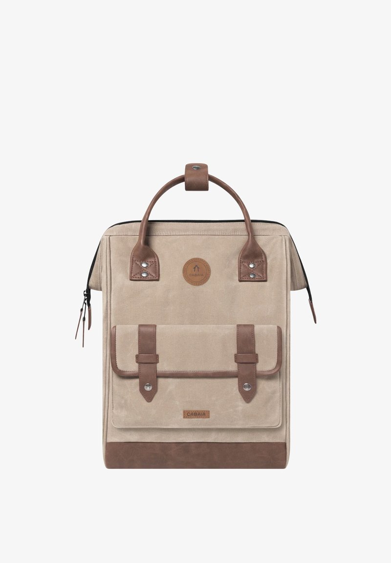Beige canvas backpack with brown leather accents, top handle, front flap pocket, and metal hardware. Zipper closure at the top.